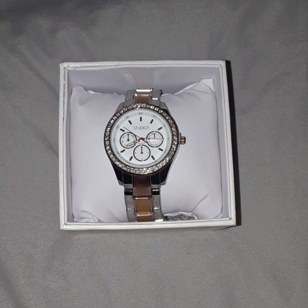 A tan goldish/sliver color watch
